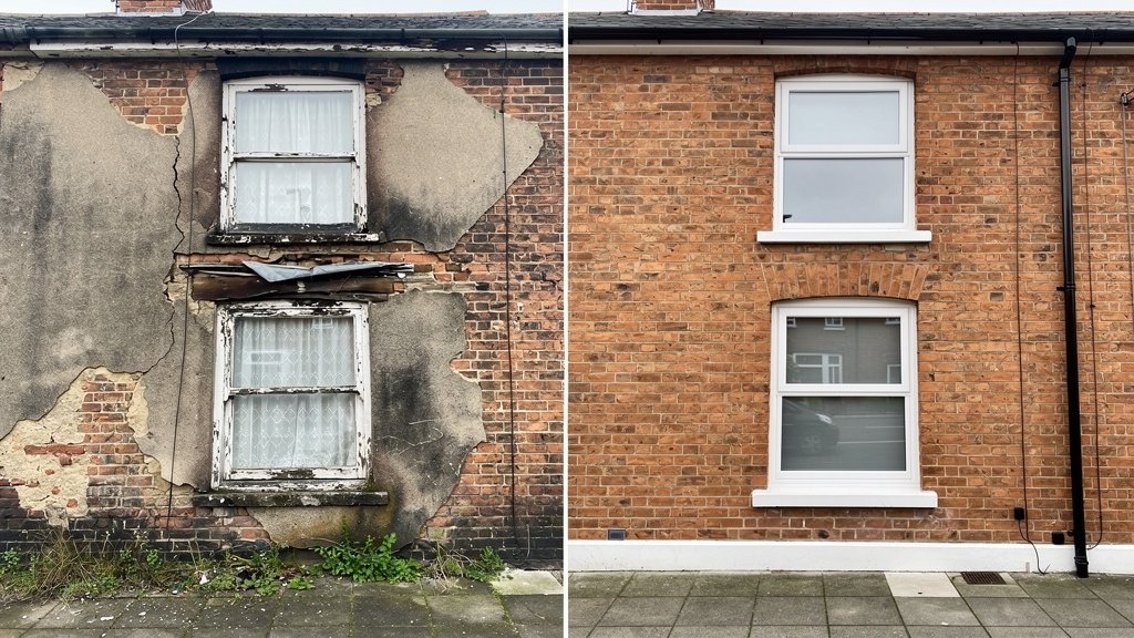 UK terraced house showing visible signs of housing disrepair including damp and cracked render